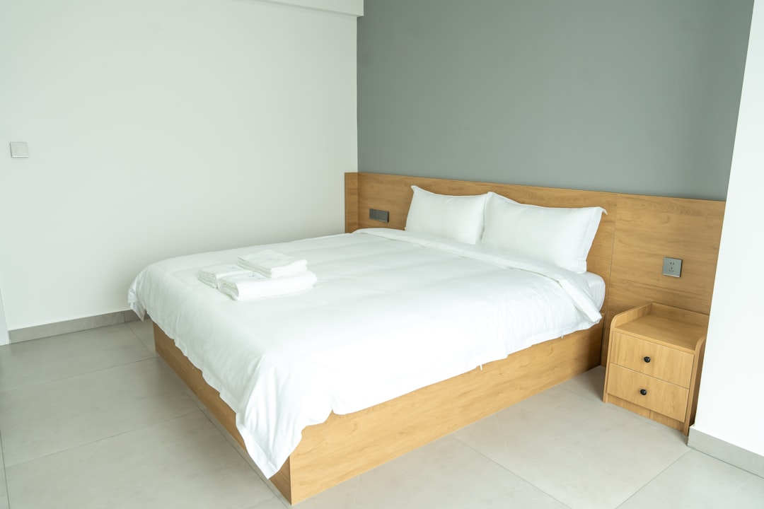 services-01 a-neatly-made-bed-in-a-modern-hotel-room-mndhu5gl-p4